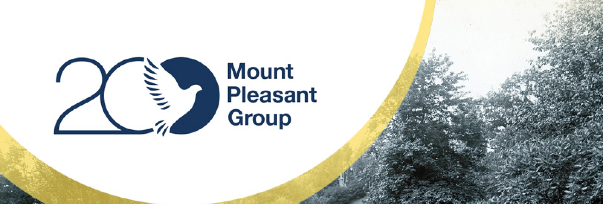 Mount Pleasant Group 20th‑anniversary logo overlaid on a vintage photograph of a winding creek surrounded by trees and landscaped greenery.