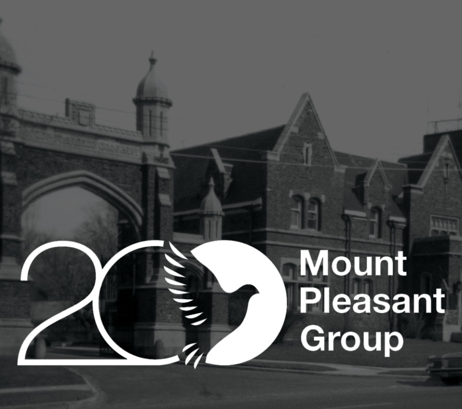 A view of the Mount Pleasant Cemetery entrance, featuring an architectural gateway with a logo centered at the top.