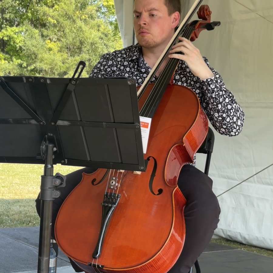 a man playing an instrument outside