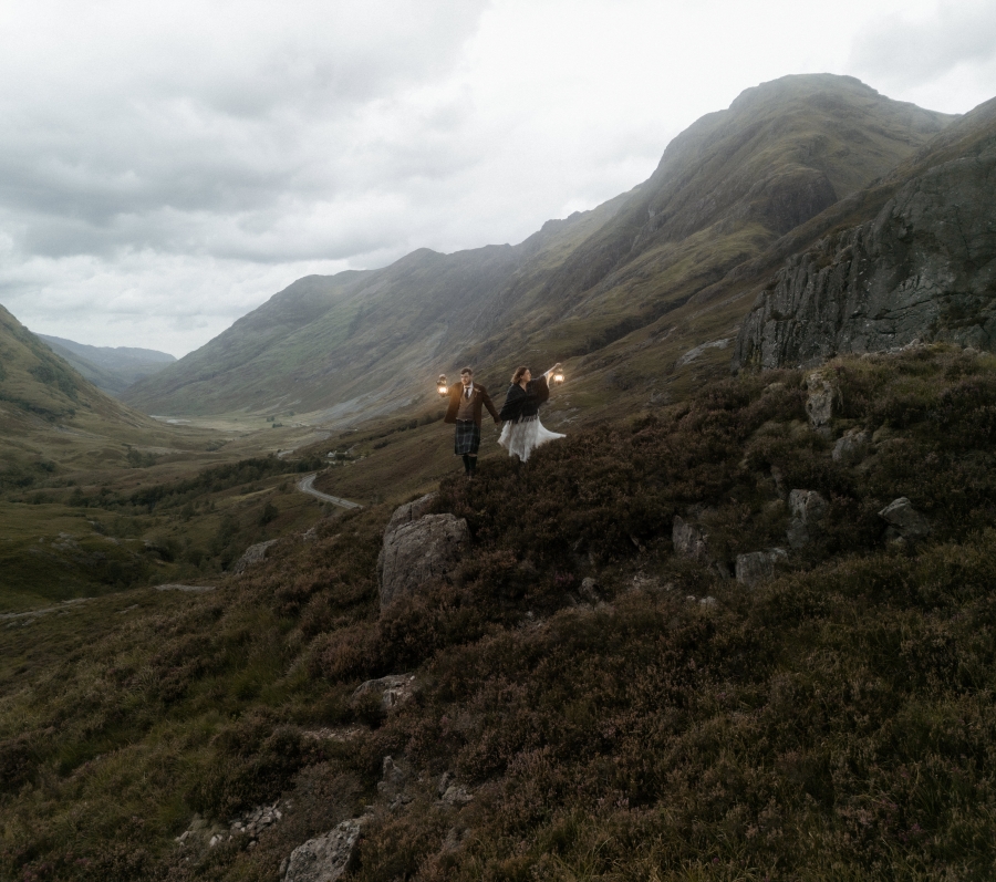 Kaitlyn and Dan standing together with a beautiful landscape in the background.