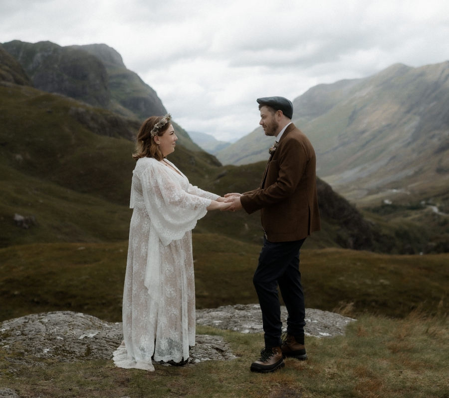 Kaitlyn and Dan standing together with a beautiful landscape in the background.
