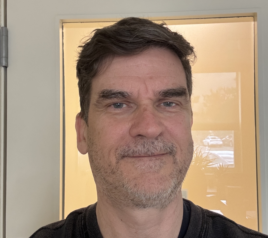 man with scruff in front of a door