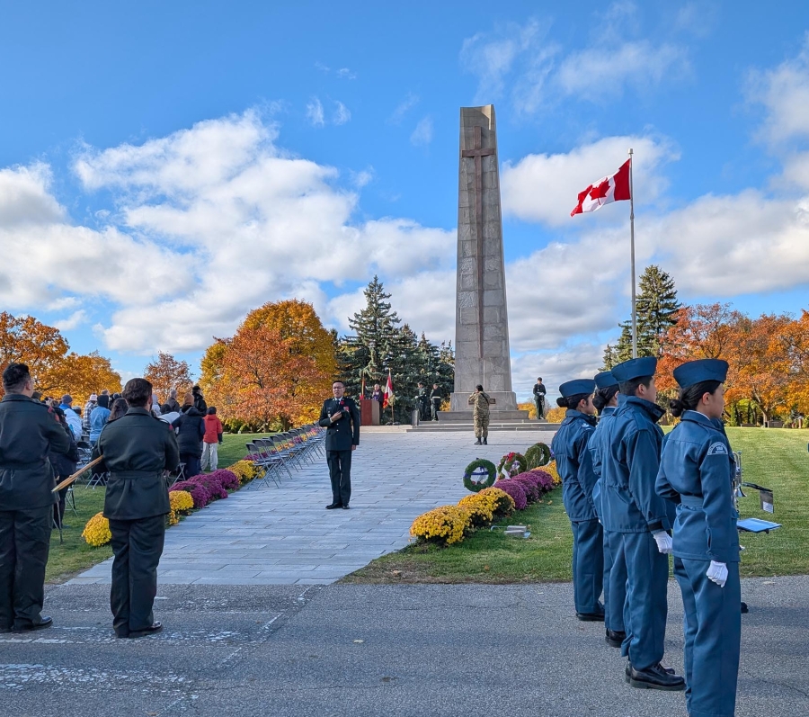 Remembrance Day ceremony at York Cemetery with uniformed personnel near a monument and Canadian flag.