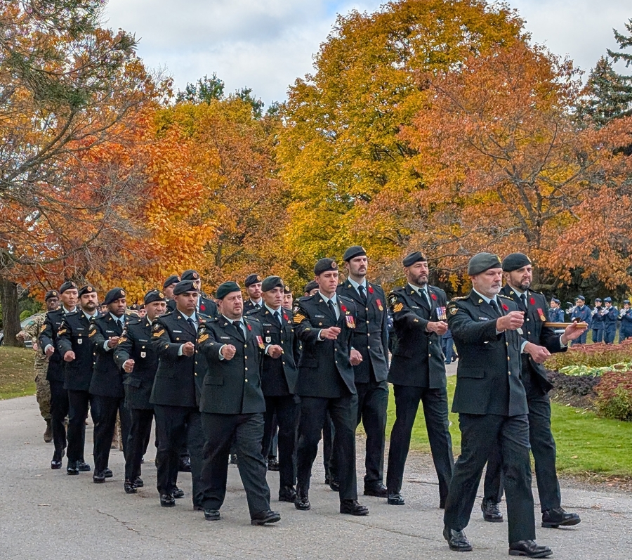 Military personnel marching in formation during Remembrance Day service at York Cemetery.