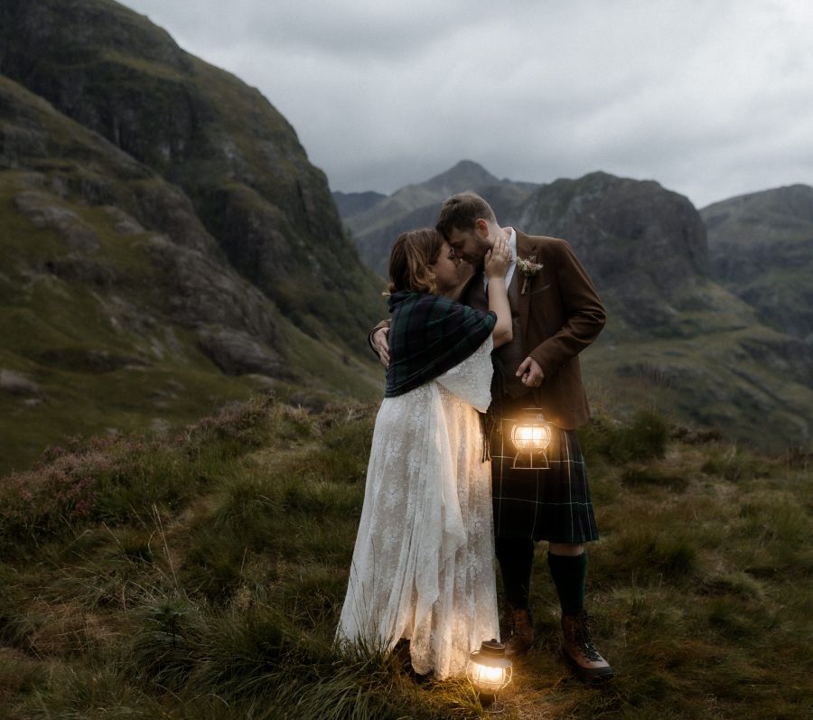 Kaitlyn and Dan standing together with a beautiful landscape in the background.
