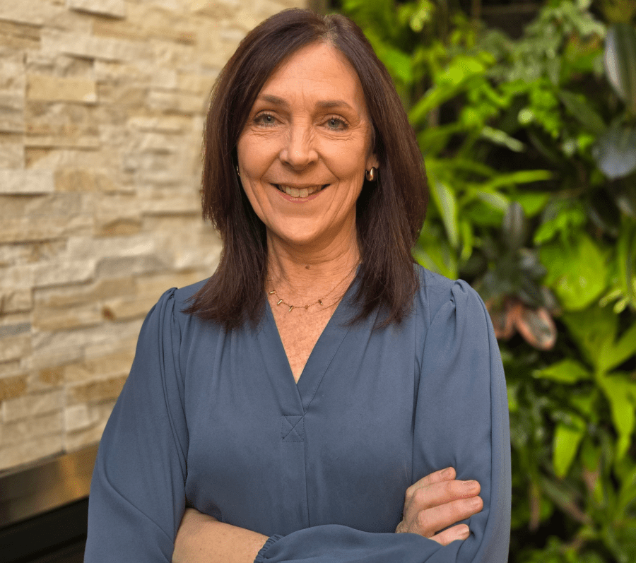 dark haired woman with her arms crossed