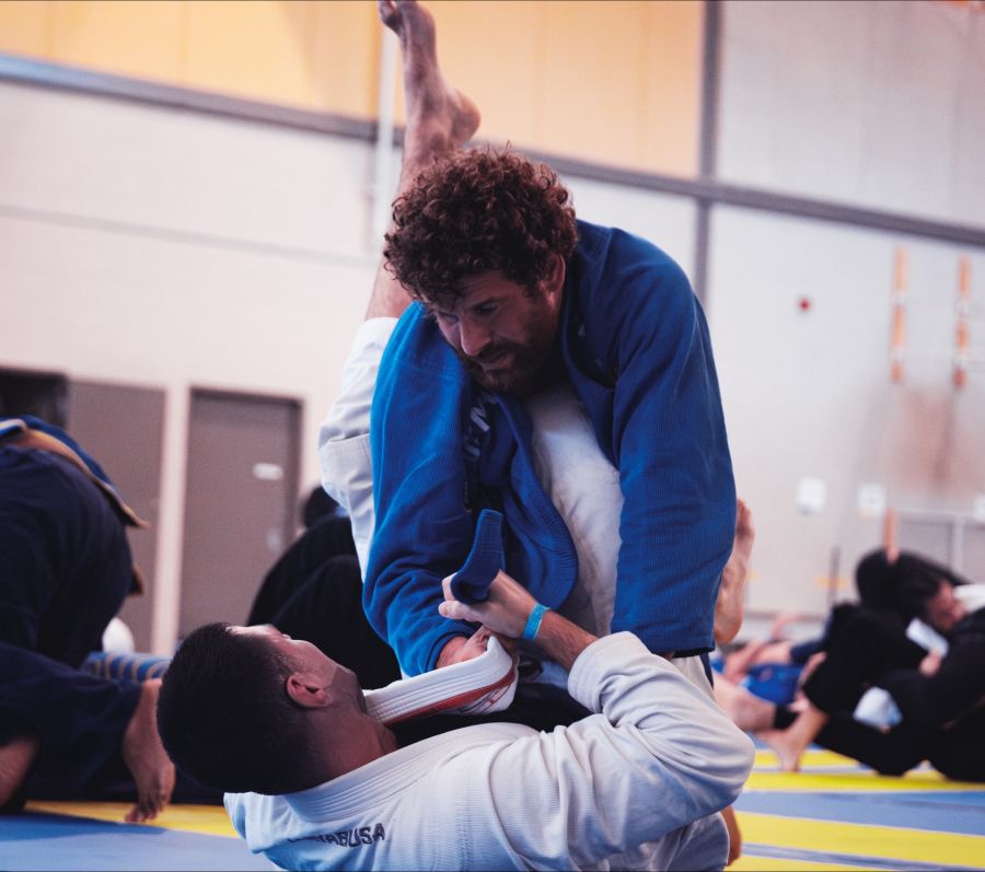 Brazilian Jiu Jitsu practitioners demonstrating a grappling technique.
