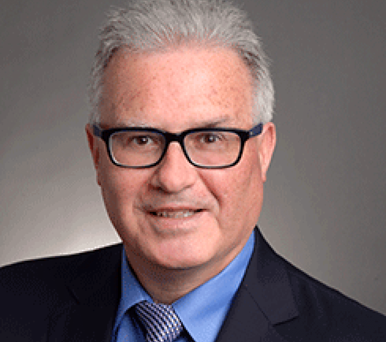 grey haired man with glasses