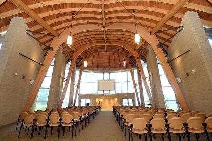 lots of chairs, wooden ceiling and glass windows
