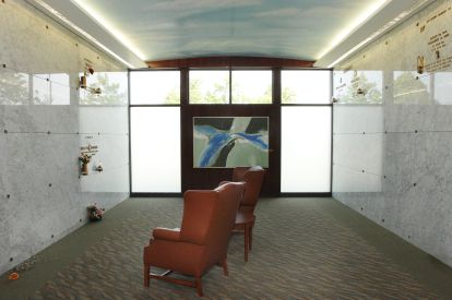 marble walls, stained glass window and leather chairs inside the mausoleum