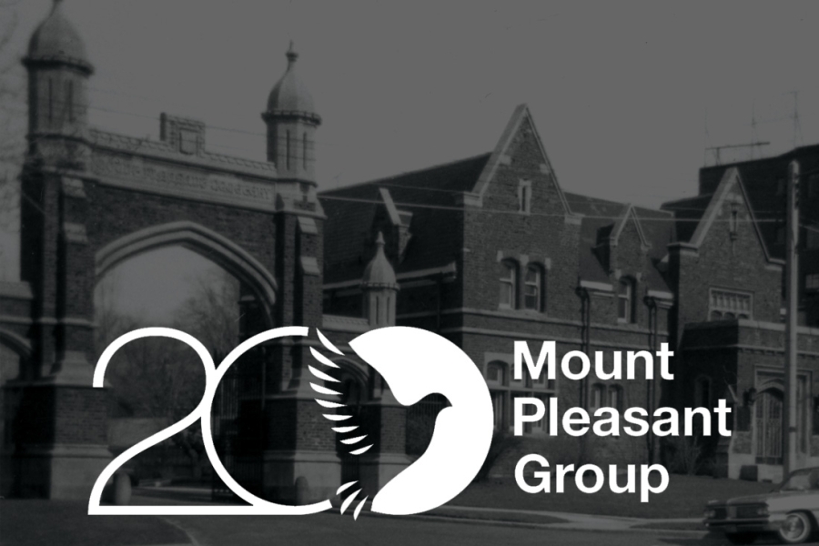 A view of the Mount Pleasant Cemetery entrance, featuring an architectural gateway with a logo centered at the top.