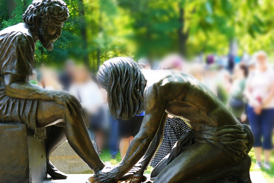 Bronze sculpture of two kneeling figures beside a basin in Mount Pleasant Cemetery.