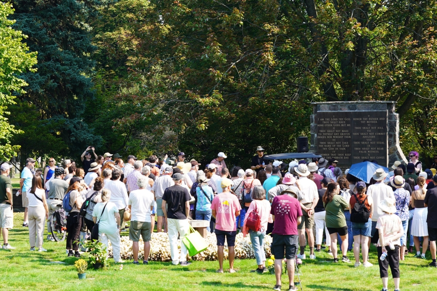 Visitors gathered around a monument at Mount Pleasant Cemetery.