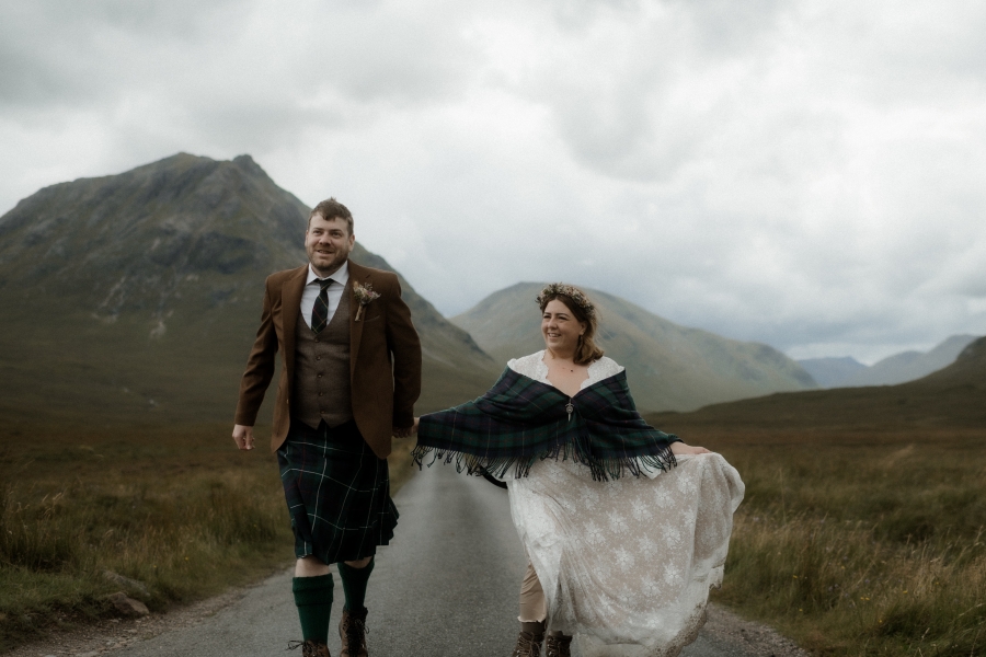 Kaitlyn and Dan standing together with a beautiful landscape in the background.