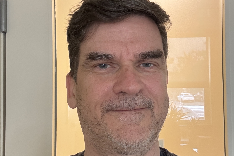 man with scruff in front of a door