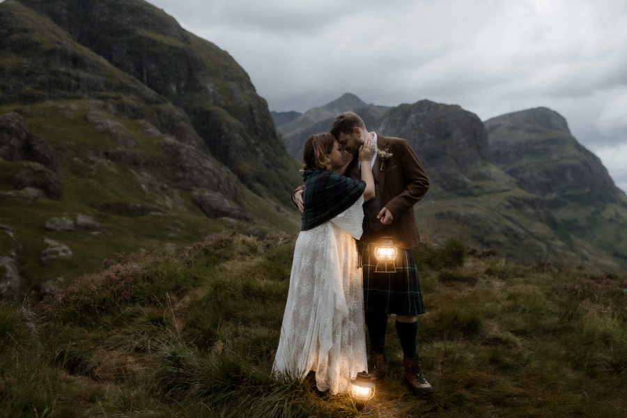 Kaitlyn and Dan standing together with a beautiful landscape in the background.
