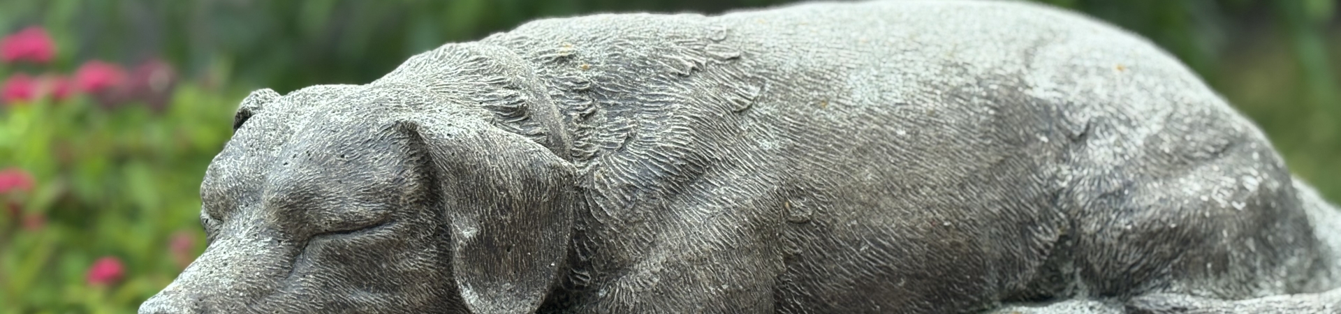 cast iron dog atop a memorial